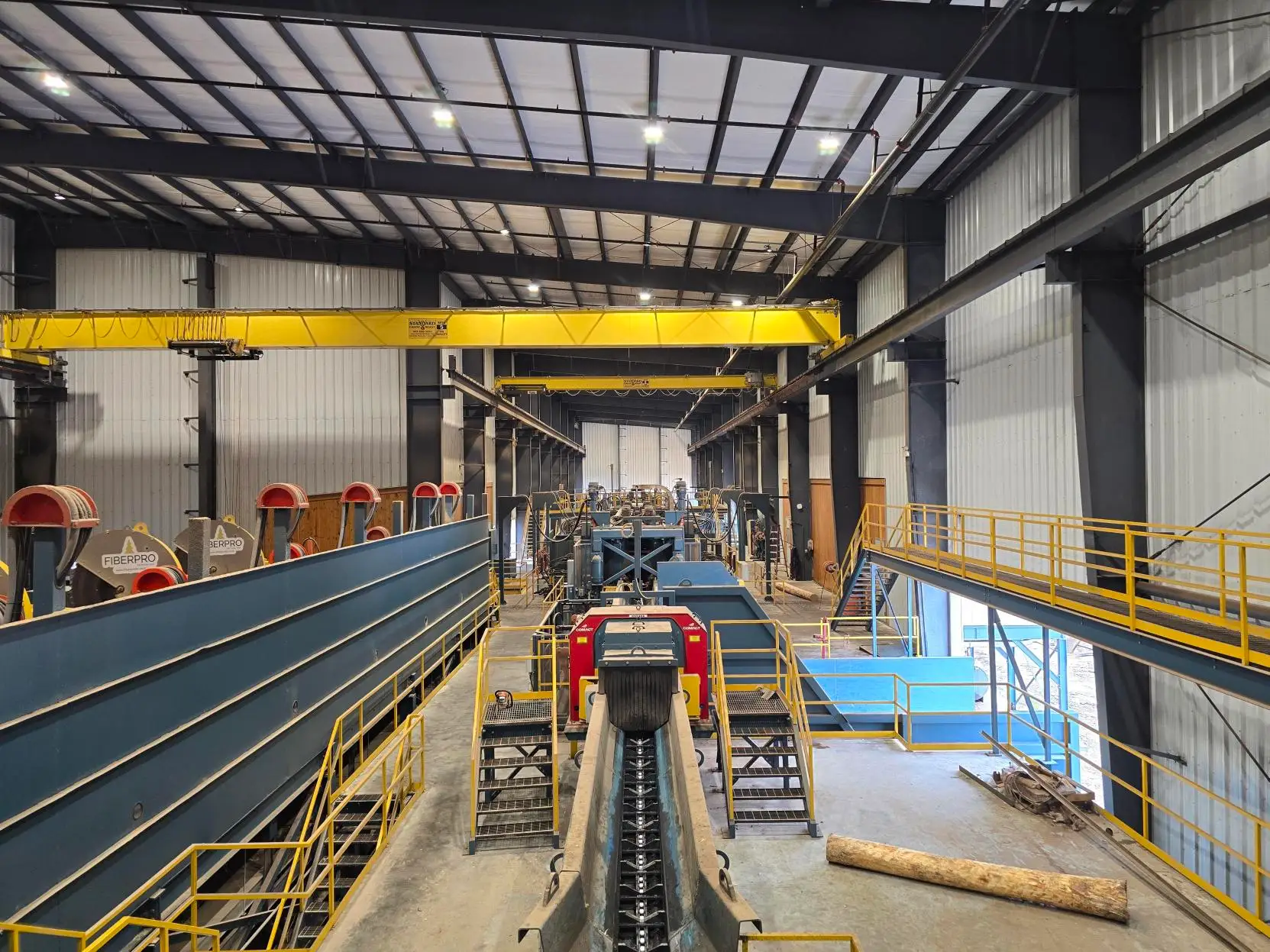 Residual conveyors and overhead cranes running the length of the mill building.