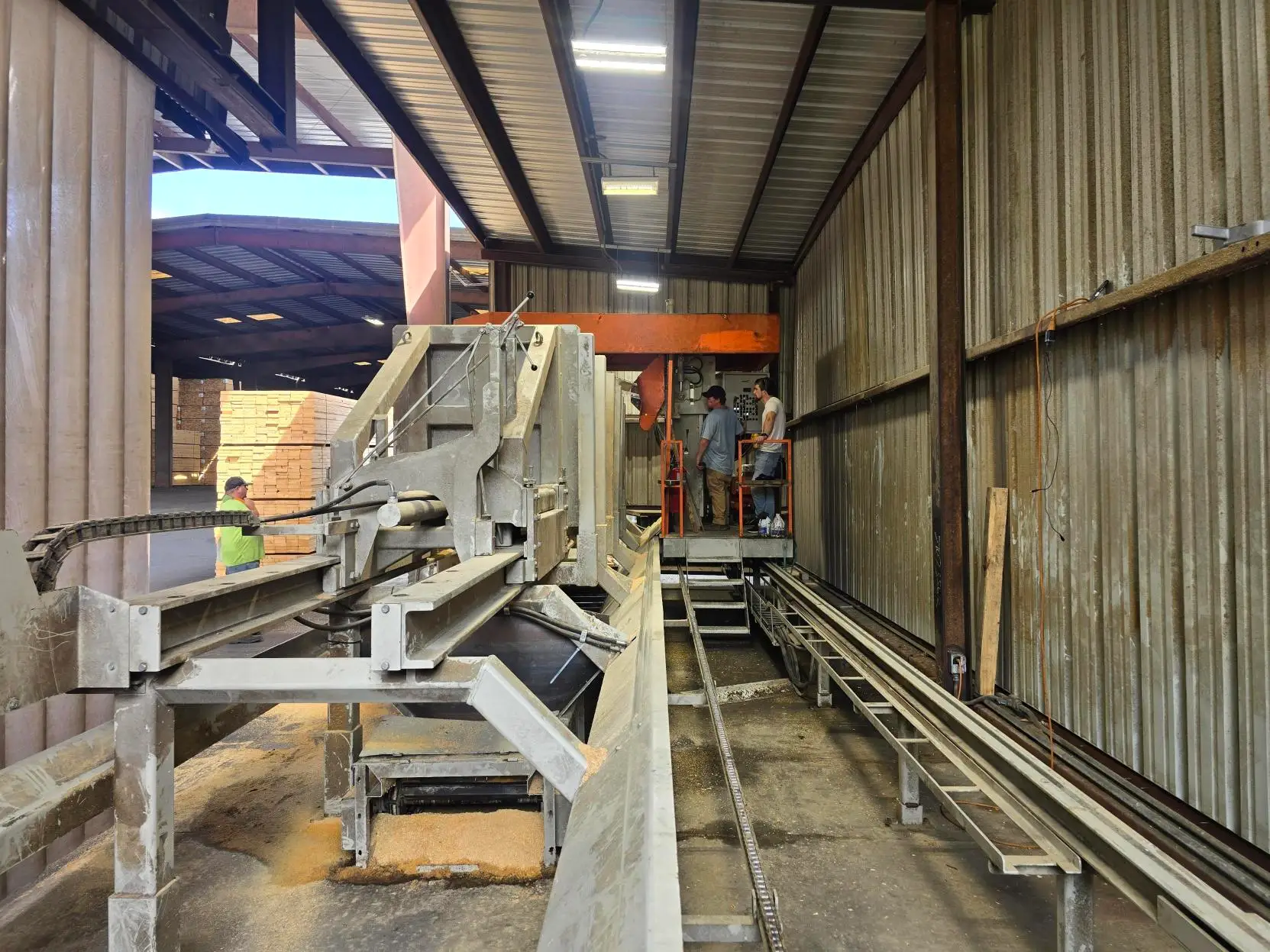 The sawmill carriage on its rails at the headrig, with the operator's booth above the line.
